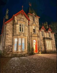 Birchwood PItlochry Building at night with indoor lights on